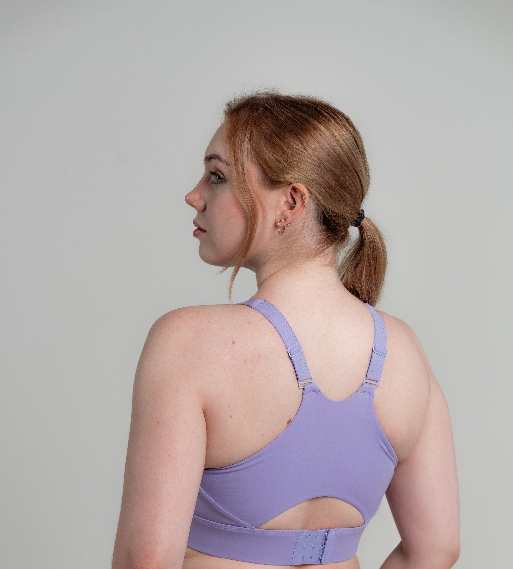 Woman in active pose wearing Soha Signature Support Bra Deep Amethyst - demonstrating locked-in support during movement