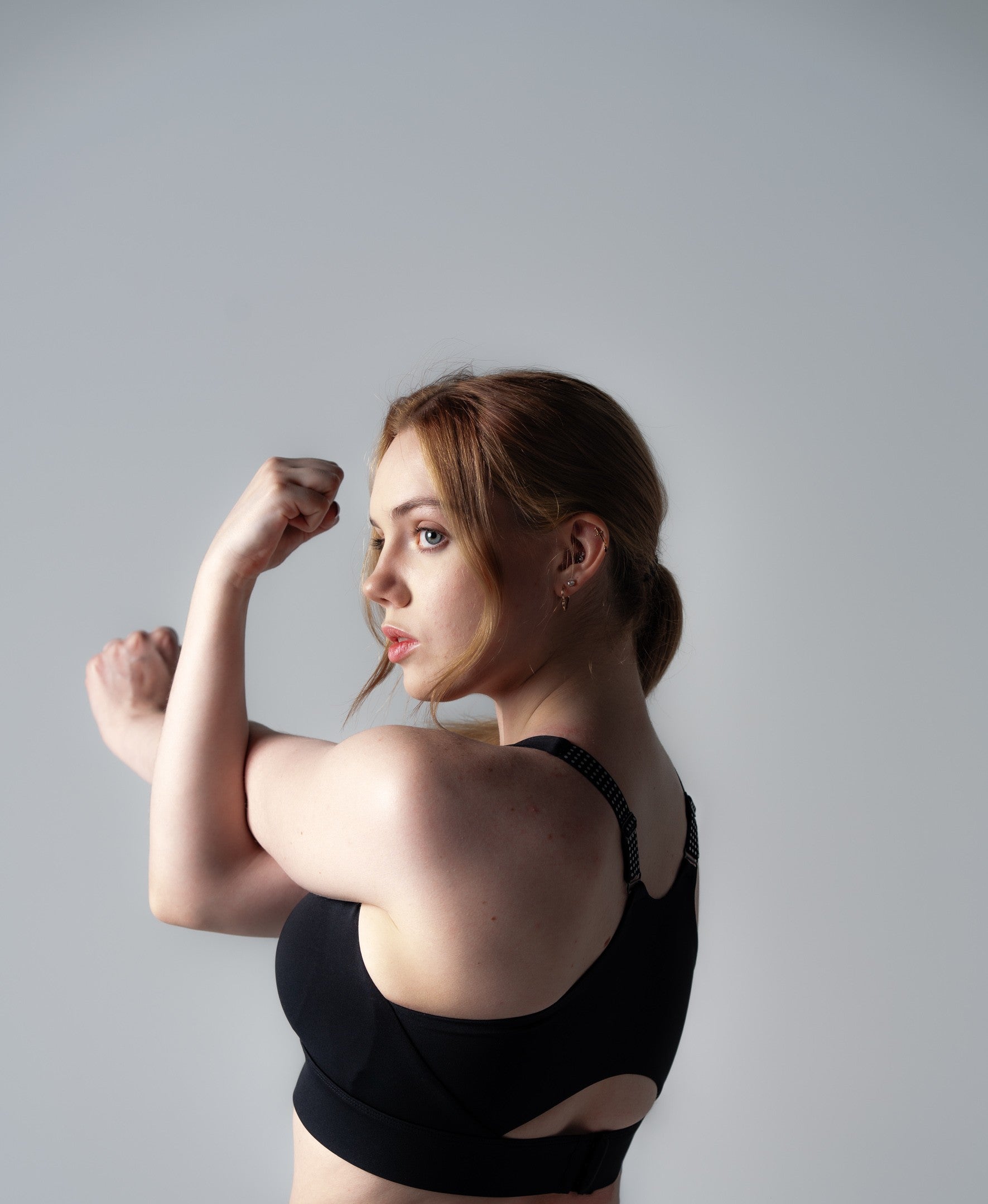 Woman in active pose wearing Soha Signature Support Bra Midnight Black - demonstrating locked-in support during movement